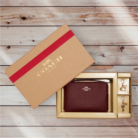 Coach Handbags - Coach Wristlet Gift Set | New in Box | 2 changeable charms | black cherry